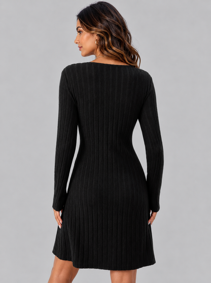 A woman wearing a black long-sleeve ribbed knit dress, shown from the back against a solid gray studio background.